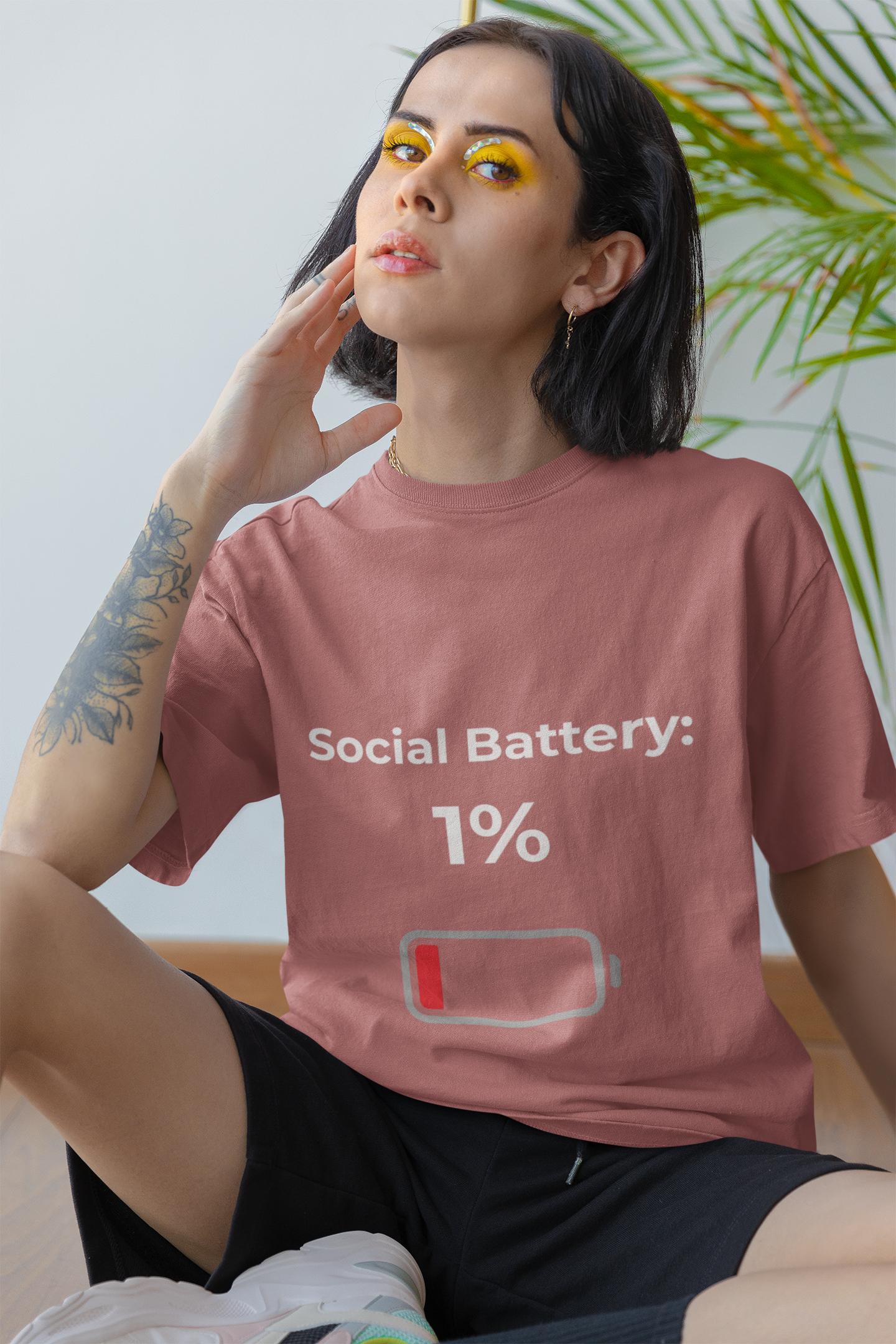 Model wearing Social Battery 1% introvert t-shirt – funny slogan shirt for low energy and mood expression